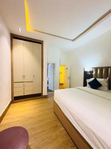 a bedroom with a large bed and a large closet at Bolton White Residence in Abuja +91 photos