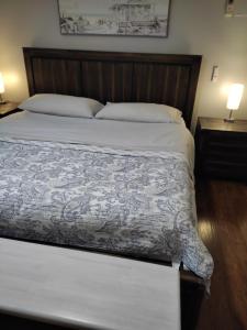 a bedroom with a large bed with a wooden headboard at Ranch with Cactuses in Millsboro