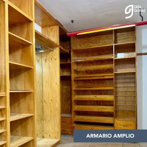 a walk in closet with wooden shelves at Talavera II in Querétaro