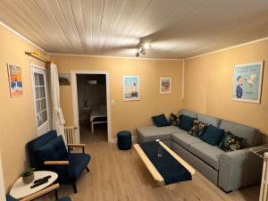 a living room with a couch and a table at Charmant T2 avec Terrasse et Parking Privé, Tout Confort, Proche Trouville - FR-1-712-88 in Touques