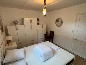 a room with a white table and a refrigerator at Charmant T2 avec Terrasse et Parking Privé, Tout Confort, Proche Trouville - FR-1-712-88 in Touques