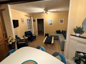 a living room with a couch and a table at Charmant T2 avec Terrasse et Parking Privé, Tout Confort, Proche Trouville - FR-1-712-88 in Touques