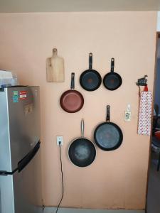 a wall with pots and pans hanging on a wall at Residencia El Navegante 1 in Mexico City