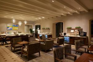 a restaurant with tables and chairs and a bar at Grand Nikko Tokyo Daiba in Tokyo