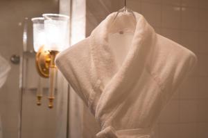 a white robe hanging in front of a shower at Grand Nikko Tokyo Daiba in Tokyo