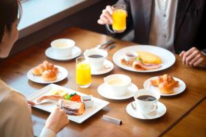 a table with plates of food and cups of coffee at Grand Nikko Tokyo Daiba in Tokyo