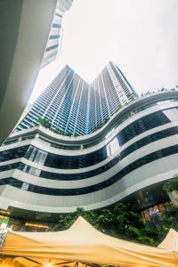 a large building with a lot of windows at Air Residence Penthouse 59 Suite Gym Swim Park 300 mbps in Manila
