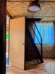 an open door in a room with a staircase at General Luna Guest House in General Luna