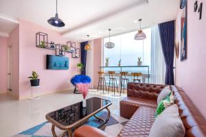 a living room with a couch and a table at Căn Hộ "2" OaSky View biển 3 Phòng 5 Giường- Oasky Sea View Apartment in Vung Tau