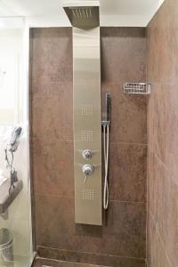 a shower with a glass door in a bathroom at Riviera Luxury Suites in Naples +54 photos