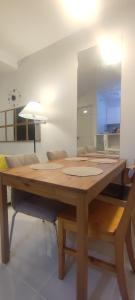 a wooden table in a living room with a mirror at Cebu Homestay Rental in Mandaue City