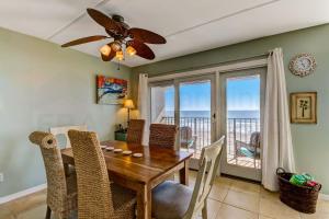 a dining room with a table and chairs and a balcony at Oceans Of Amelia - 315 Condo in Fernandina Beach