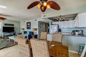 a kitchen and dining room with a ceiling fan at Oceans Of Amelia - 315 Condo in Fernandina Beach