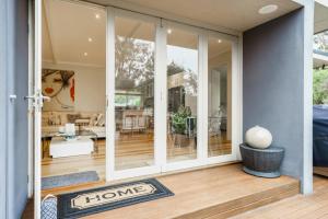 a home with sliding glass doors and a living room at Bella Rye by Ready Set Stay - BYO LINEN & TOWELS in Rye