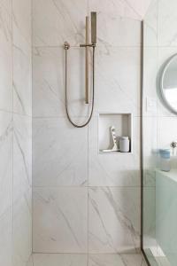 a bathroom with a shower with a glass door at Potager B&B- Waiohine- Greytown in Greytown