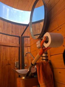 a bathroom with a toilet paper holder and a sink at Chalet Contenedor con Hot Tub exterior exclusivo in Las Palmas