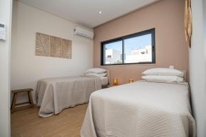 a room with two beds and a window at CASA MARGARIDA, Arte Nova in Fuzeta +38 photos