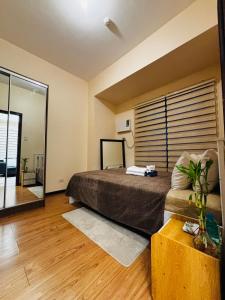a bedroom with a bed and a large window at Relaxation Getaway in Manila +16 photos