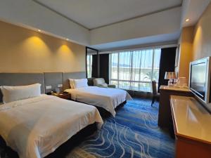 Letto o letti in una camera di Dongguan Well Garden Hotel