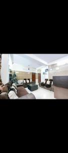 a living room with a couch and a christmas tree at rudra cottage in Shimla