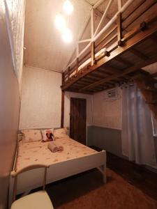 a small room with a bunk bed and a ladder at Rosie's Beach House El Nido in El Nido
