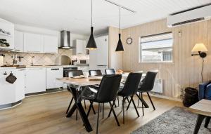 a kitchen and dining room with a table and chairs at 3 Bedroom Lovely Home In Sydals in Neder Lysabild