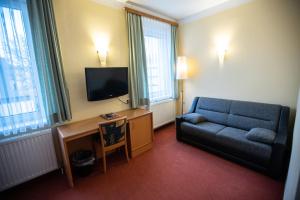 TV a/nebo společenská místnost v ubytování Hotel Stadt Wien
