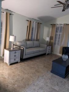 a living room with a couch and a table at Bridgeview Arcadia Three in Portmore