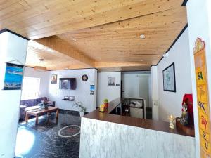a living room with a wooden ceiling at Ghasso Residency in Gangtok +20 photos