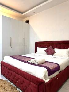 a bed with a red headboard in a bedroom at Fortune Home Service Apartment 2Bhk ,E28 Saket 1A in New Delhi