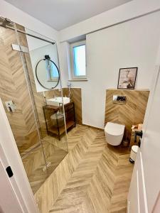 a bathroom with a shower and a toilet and a sink at Bucovina Home Apartament in Gura Humorului