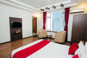 Postel nebo postele na pokoji v ubytování OYO 11474 Gangaur Regency Boutique Hotel