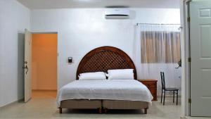 Postel nebo postele na pokoji v ubytování Hotel Hacienda Margot