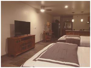a bedroom with two beds and a flat screen tv at Harbour Inn in Cross Roads