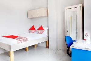 Postel nebo postele na pokoji v ubytování OYO 120 GP Residence