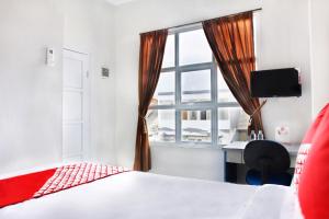 Postel nebo postele na pokoji v ubytování OYO 120 GP Residence