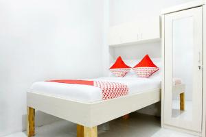 Postel nebo postele na pokoji v ubytování OYO 120 GP Residence