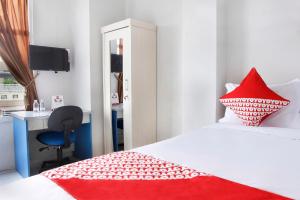 Postel nebo postele na pokoji v ubytování OYO 120 GP Residence