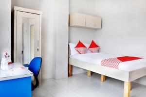 Postel nebo postele na pokoji v ubytování OYO 120 GP Residence