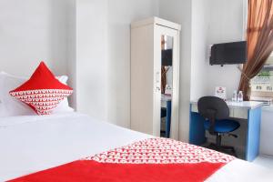 Postel nebo postele na pokoji v ubytování OYO 120 GP Residence