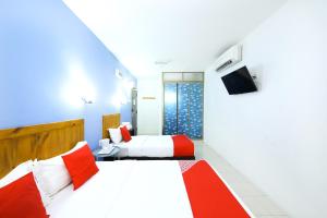 Postel nebo postele na pokoji v ubytování Super OYO 502 Midah Inn Puchong