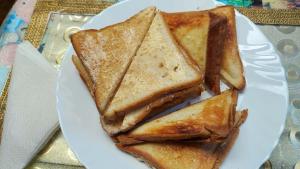 a white plate topped with slices of toast at Viraj Kunj Homestay in Darjeeling