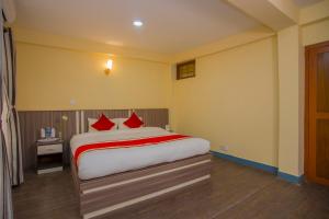 Letto o letti in una camera di OYO 297 Hotel Aayam