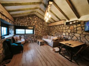 a living room with a couch and a table at Stone House Montenegro in Danilovgrad
