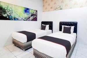 Postel nebo postele na pokoji v ubytování Hotel O Jalan Jenderal Sudirman Near Imam Bonjol Square