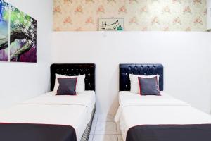 Postel nebo postele na pokoji v ubytování Hotel O Jalan Jenderal Sudirman Near Imam Bonjol Square