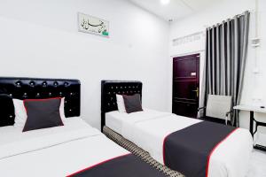 Postel nebo postele na pokoji v ubytování Hotel O Jalan Jenderal Sudirman Near Imam Bonjol Square