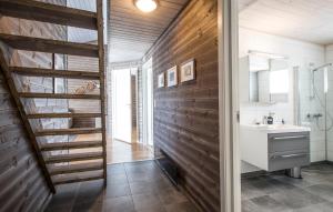 a bathroom with a sink and a wooden wall at 2 Bedroom Cozy Apartment In Stranda in Stranda