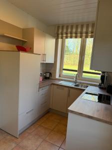 a kitchen with a white refrigerator and a sink at Apartment 4 in Wyk auf Föhr +3 photos