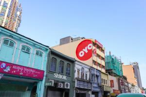 a busy city street with tall buildings and a sign at OYO 761 City Hotel in Kuala Lumpur